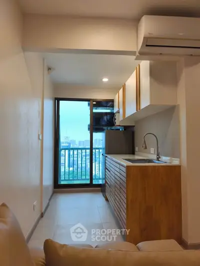 Modern apartment kitchen with open layout and city view balcony