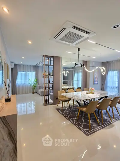 Luxurious open-plan dining area with modern lighting and elegant decor