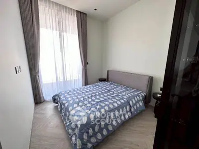 Cozy bedroom with modern decor and large window for natural light