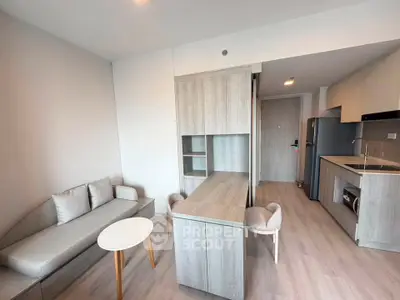 Modern living room with sleek furniture and open kitchen layout