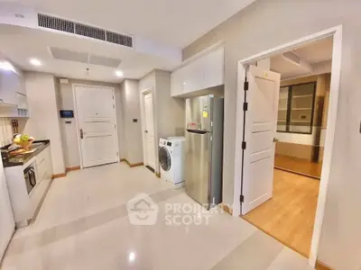 Modern kitchen with washing machine and fridge in open layout apartment