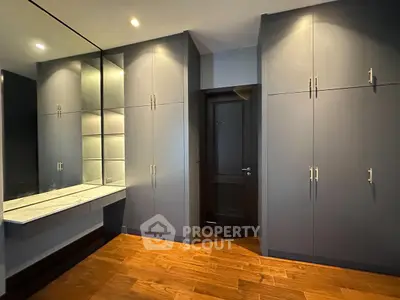Spacious modern storage room with sleek cabinets and wooden flooring