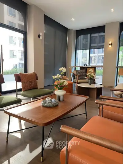 Stylish modern living room with elegant furniture and large windows in a contemporary apartment.