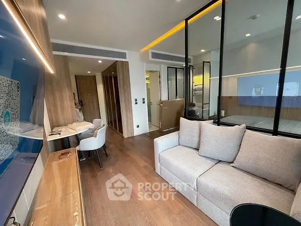 Modern living room with glass partition and stylish decor