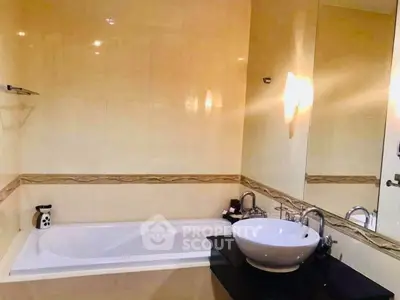 Elegant bathroom with modern fixtures and a luxurious bathtub in a stylish real estate property.