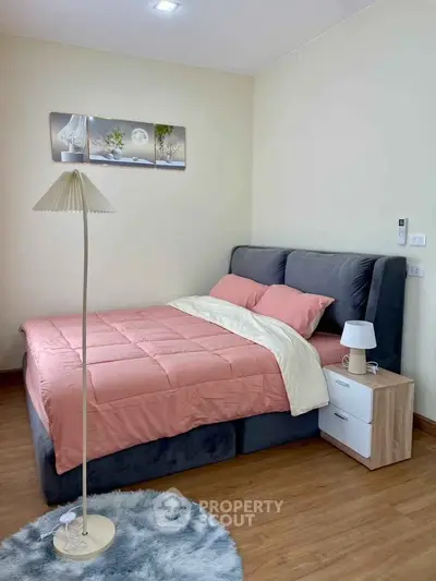 Cozy bedroom with modern decor and plush bedding in a stylish apartment.