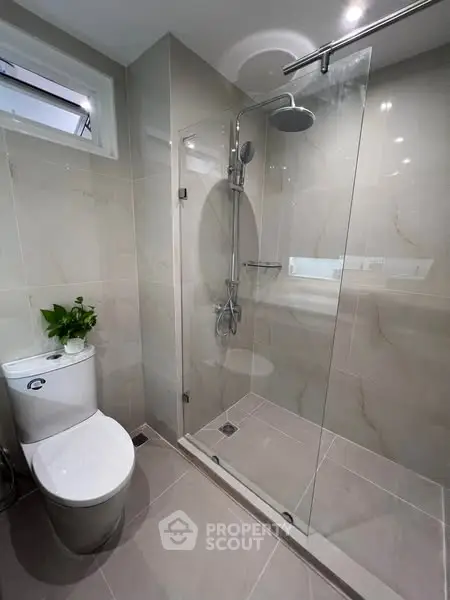 Modern bathroom with glass shower and sleek fixtures