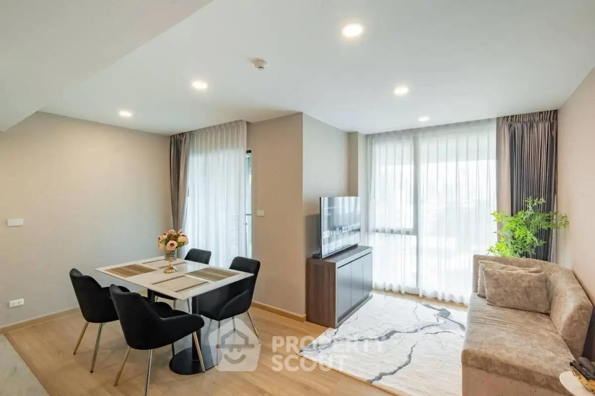 Modern living room with dining area, stylish decor, and natural light in a contemporary apartment.