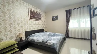 Cozy bedroom with elegant wallpaper and natural light