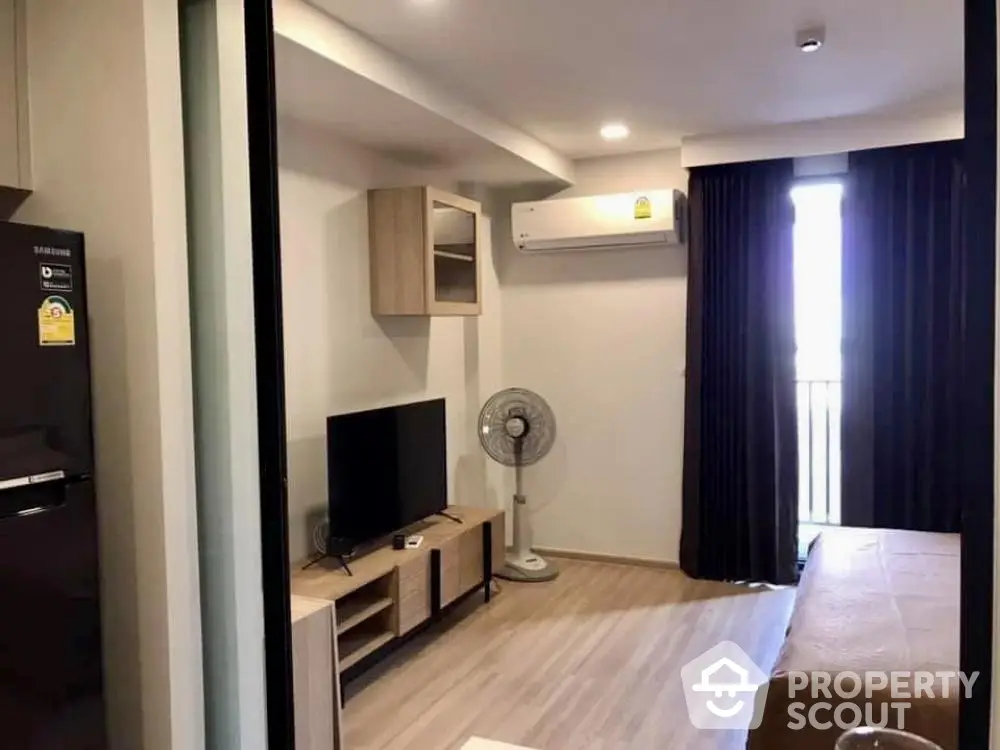 Modern living room with air conditioning and balcony access in stylish apartment.