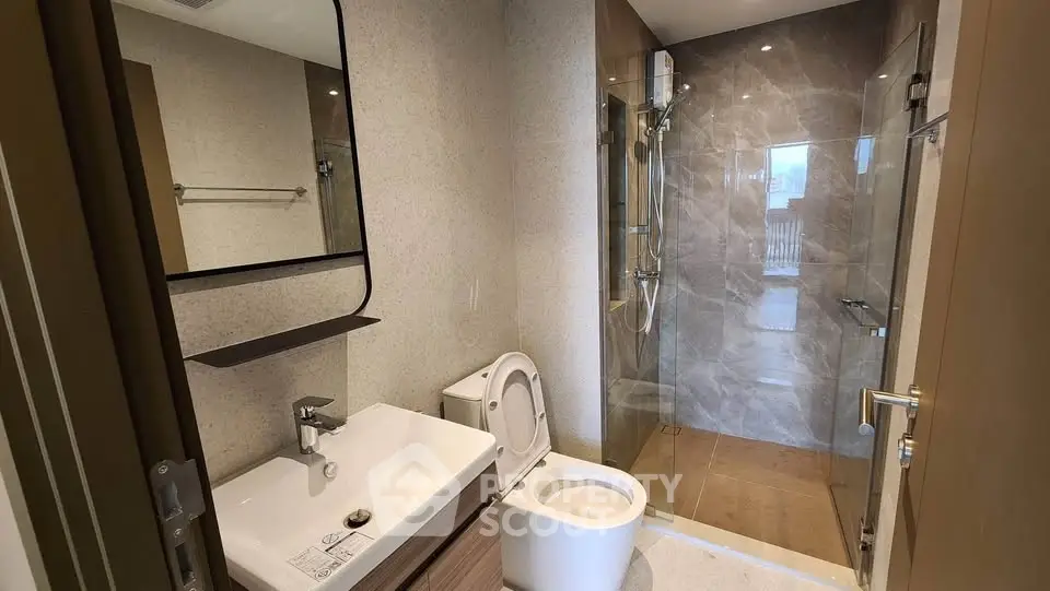 Modern bathroom with sleek fixtures and glass shower enclosure