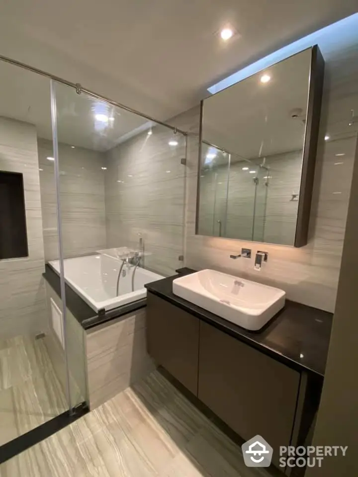 Luxurious modern bathroom with glass shower and sleek vanity