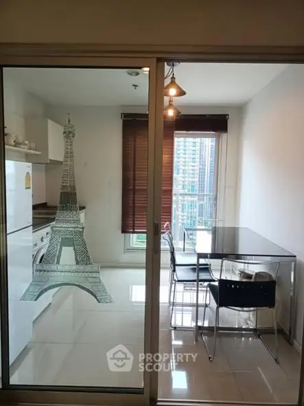 Modern kitchen with glass dining table and city view