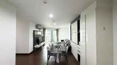 Spacious modern living room with dining area and balcony view