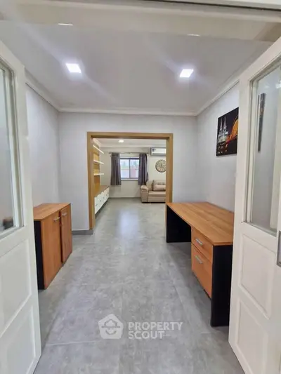 Spacious open-plan living area with modern furnishings and ample natural light.