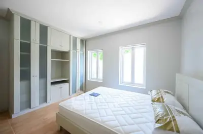 Spacious bedroom with built-in wardrobe and natural light