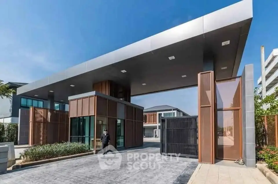 Modern gated entrance with sleek architectural design and secure access, perfect for luxury living.