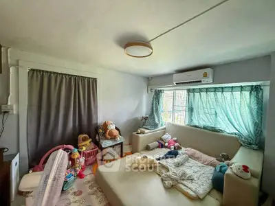 Cozy living room with plush seating and toys, perfect for family relaxation.