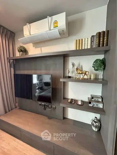 Modern living room with stylish shelving and mounted TV