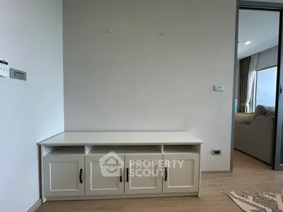 Modern interior with sleek storage unit and open living room view