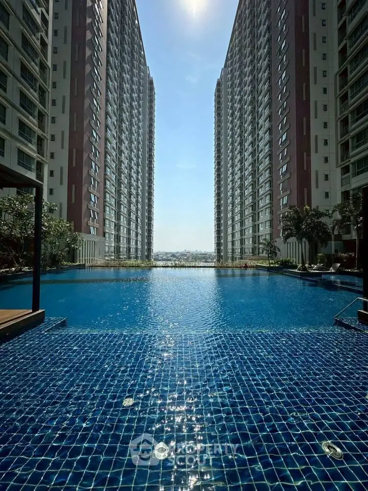 Luxurious high-rise apartment complex with stunning pool and city view