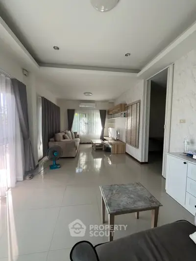 Spacious living room with modern decor and natural light