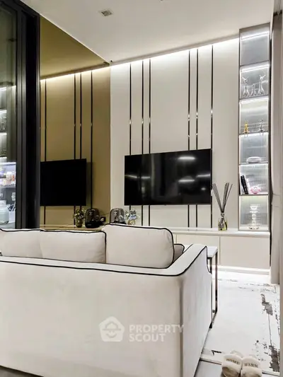 Modern living room with sleek TV setup and elegant shelving, perfect for stylish urban living.