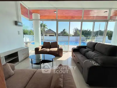 Luxurious living room with pool view and modern furniture