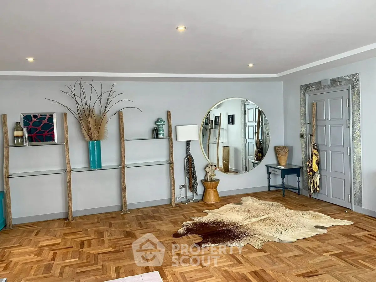 Stylish living room with parquet flooring, unique decor, and large round mirror