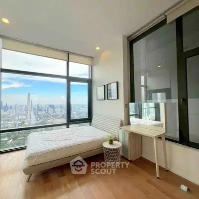 Luxurious bedroom with stunning city view and modern decor in high-rise apartment.