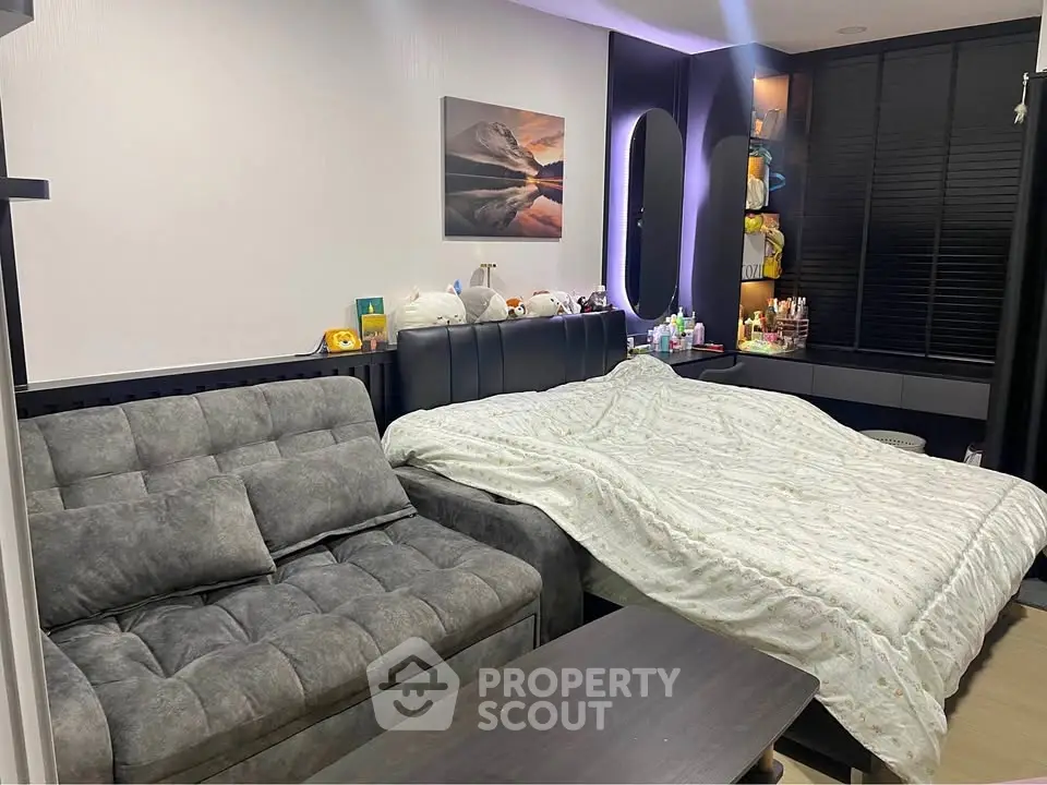 Cozy bedroom with modern decor and comfortable seating area