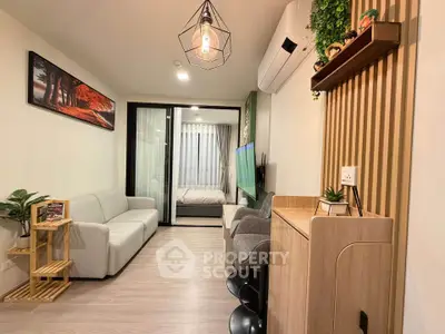 Modern living room with stylish decor and open view to bedroom