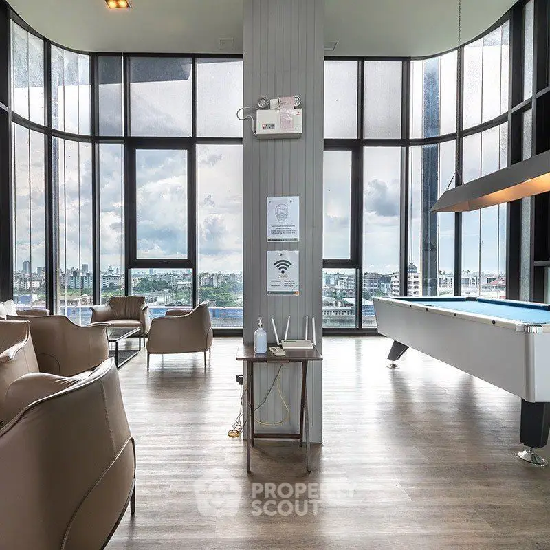 Luxurious high-rise building lounge with panoramic city views and modern amenities.