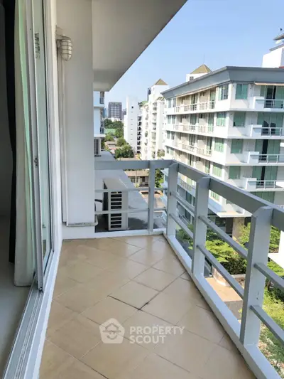 Spacious balcony with city view in modern apartment building