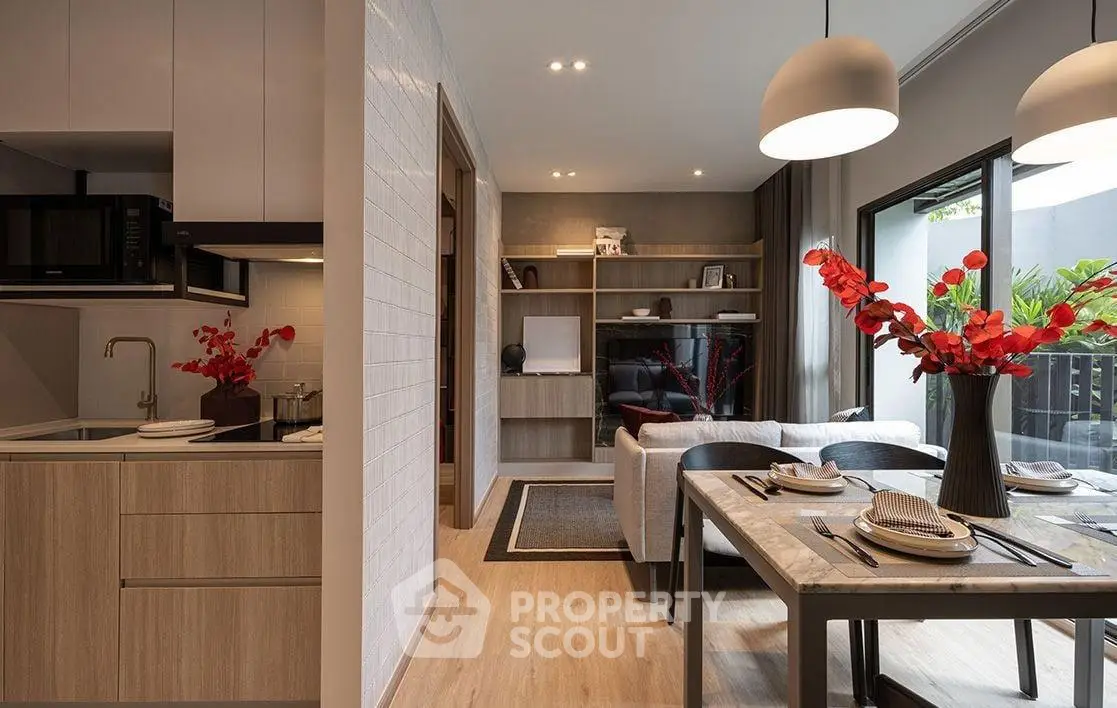 Modern open-plan living room and kitchen with stylish decor and natural light.