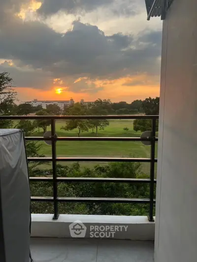 Stunning balcony view with sunset over lush green landscape