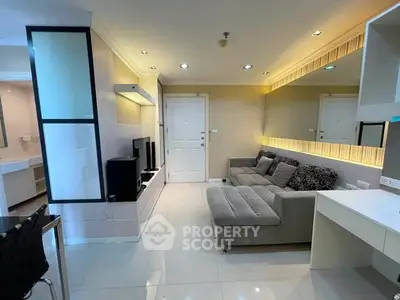 Modern living room with stylish decor and cozy seating in a contemporary apartment.
