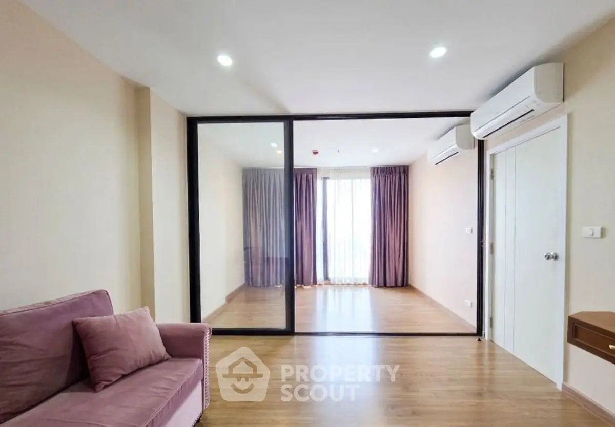 Spacious living room with glass partition and elegant curtains