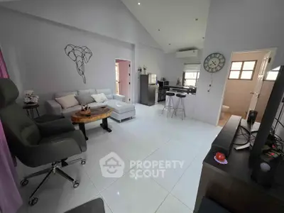 Spacious modern living room with open kitchen and sleek furnishings