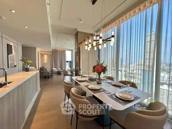 Luxurious open-plan dining and living area with panoramic city views and elegant decor.