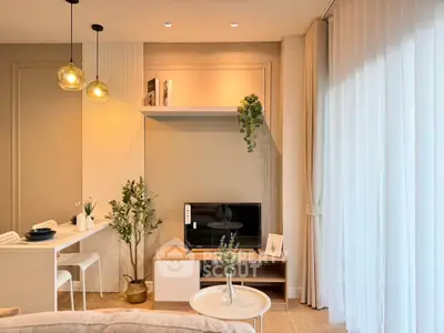 Modern living room with stylish decor and natural light, featuring a cozy seating area and elegant lighting.