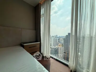 Luxurious bedroom with stunning city view and floor-to-ceiling windows in modern high-rise apartment.