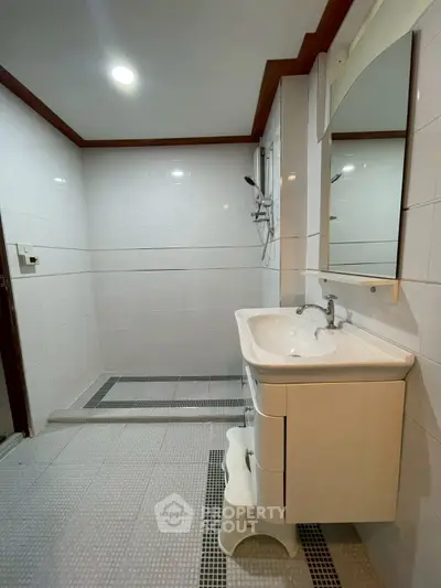 Spacious bathroom with modern fixtures and elegant tile design
