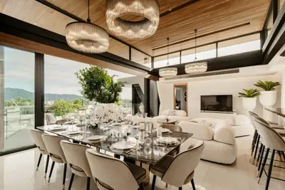Luxurious open-plan living and dining area with modern decor and stunning views.
