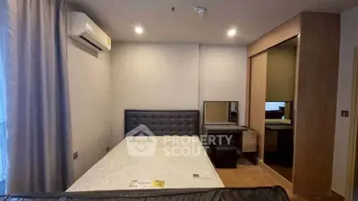 Modern bedroom with sleek design, featuring a comfortable bed, air conditioning, and ample storage space.