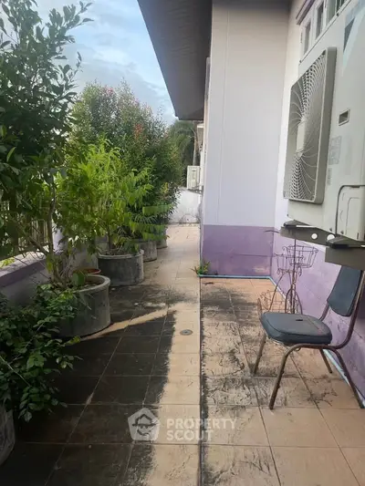Charming balcony with lush greenery and seating area, perfect for relaxation and enjoying fresh air.