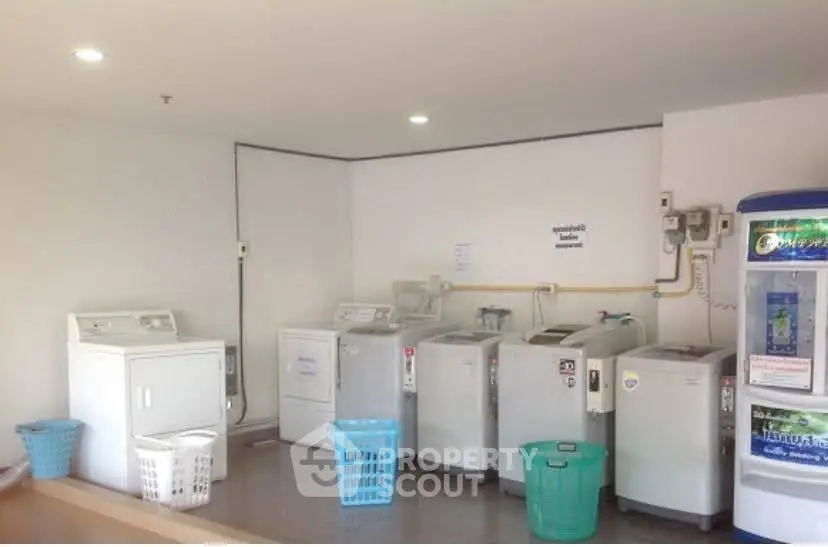 Spacious laundry room with multiple washing machines and dryers