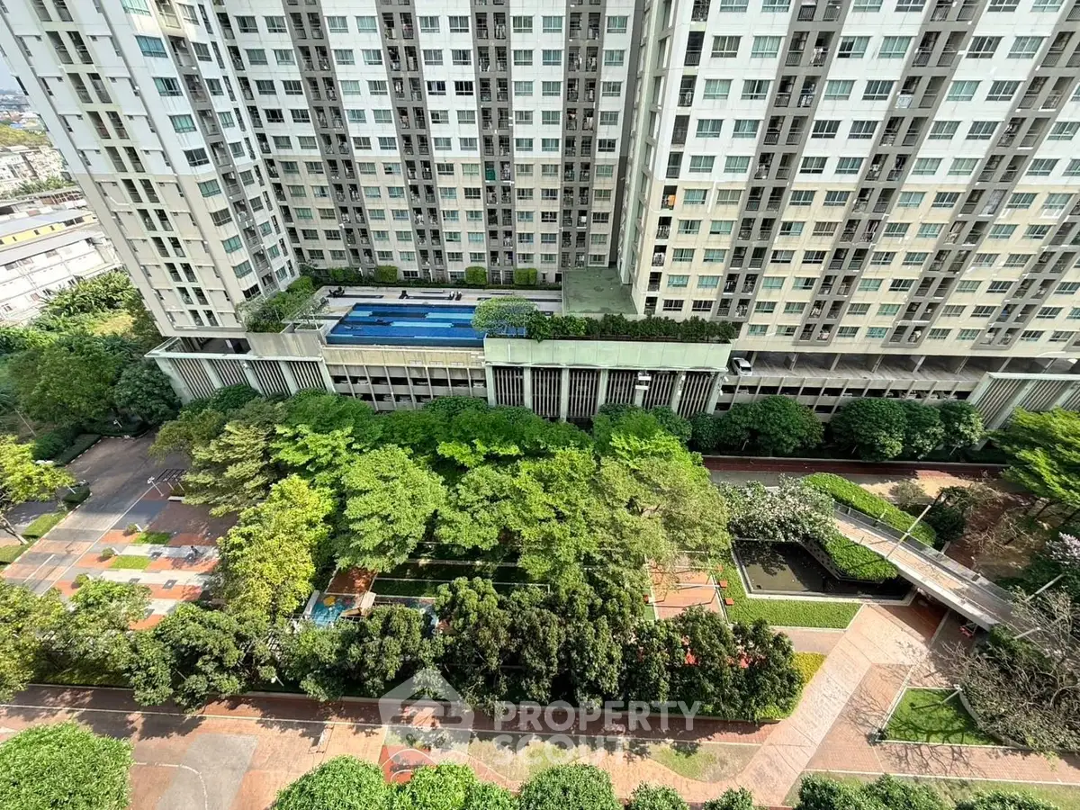 High-rise building with lush garden and pool view from above