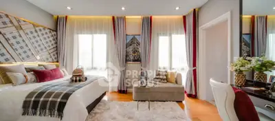 Luxurious bedroom with elegant decor and plush furnishings, featuring a cozy seating area and stylish accents.