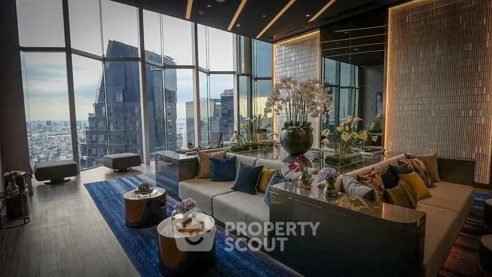 Luxurious high-rise living room with panoramic city views and elegant decor.